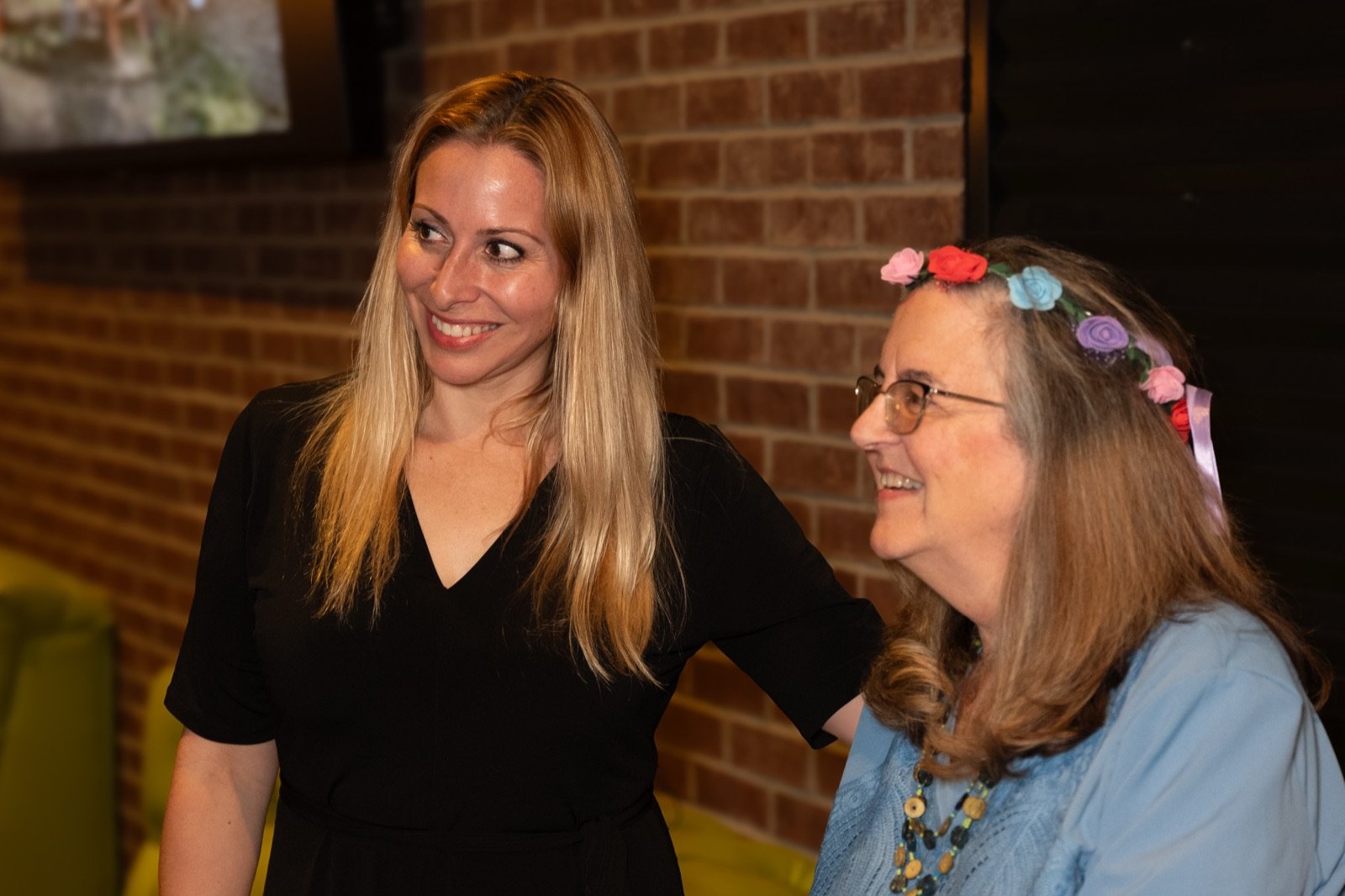 Two guests smiling together at the end of the night
